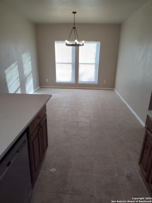 unfurnished dining area with a chandelier