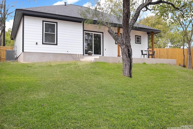 rear view of property with a yard