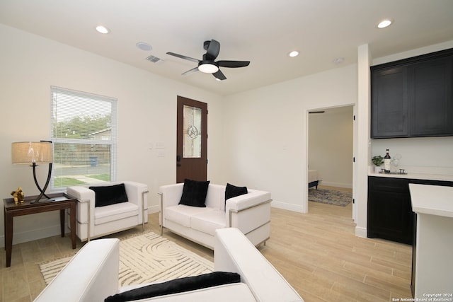 living room with ceiling fan and light hardwood / wood-style floors