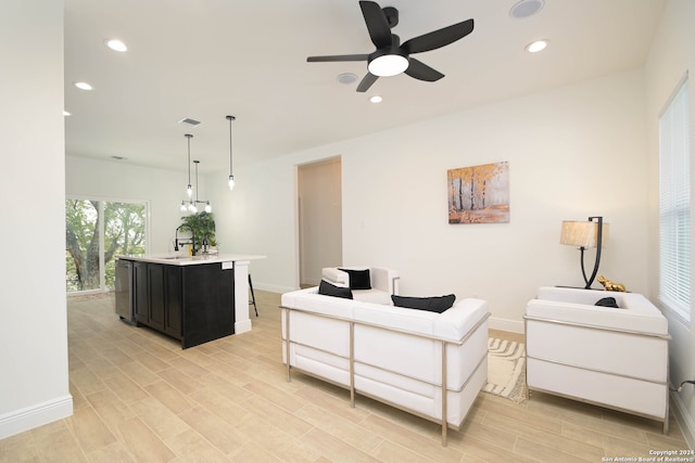 living room featuring light hardwood / wood-style flooring and ceiling fan