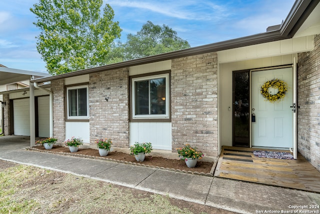 view of exterior entry with a garage