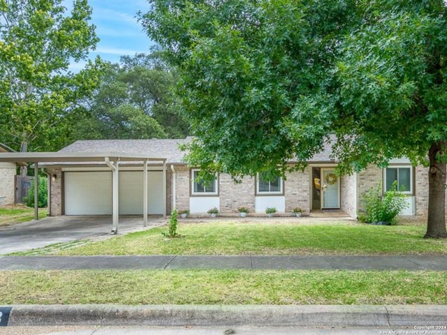 view of front of home with a garage and a front lawn