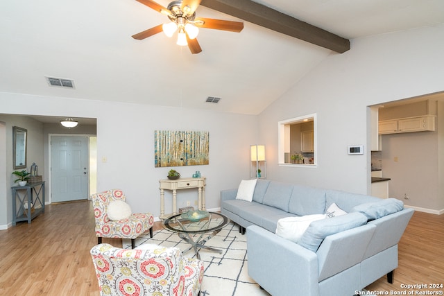 living room with vaulted ceiling with beams, ceiling fan, and light hardwood / wood-style floors