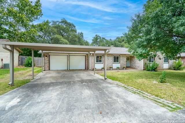 single story home with a front yard, central AC, a garage, and a carport