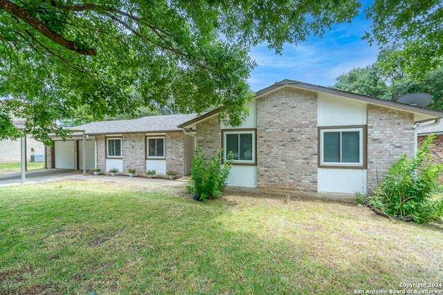 single story home featuring a front lawn and a garage