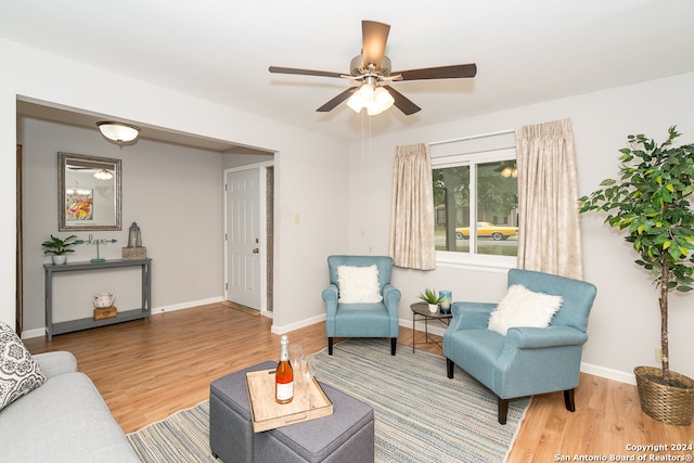 living room featuring hardwood / wood-style floors and ceiling fan