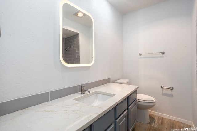 bathroom featuring hardwood / wood-style floors, vanity, and toilet