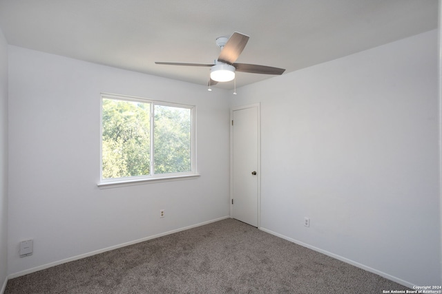 empty room featuring ceiling fan and carpet floors