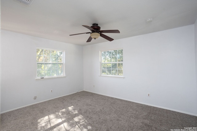 carpeted empty room featuring ceiling fan