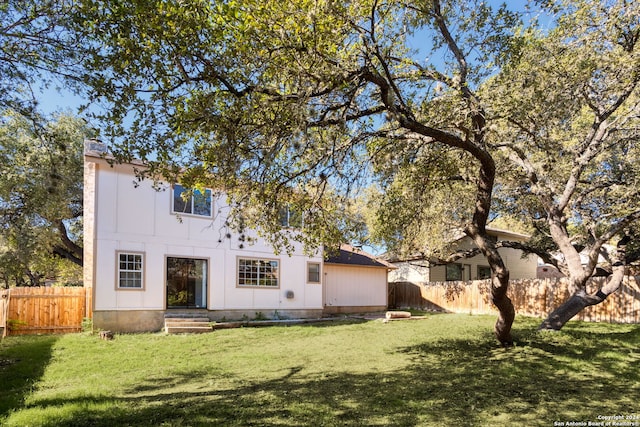 rear view of house with a lawn