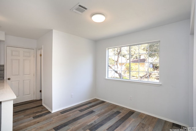 unfurnished room featuring dark hardwood / wood-style floors