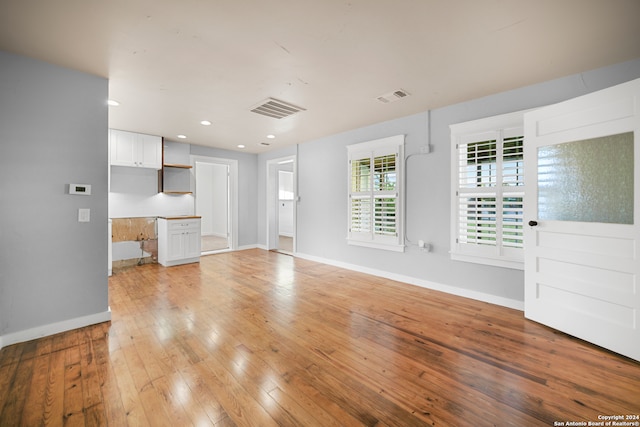 unfurnished living room featuring light wood-type flooring