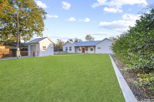 exterior space with an outbuilding, a garage, and a front yard