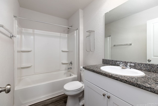 full bathroom featuring shower / washtub combination, hardwood / wood-style floors, vanity, and toilet