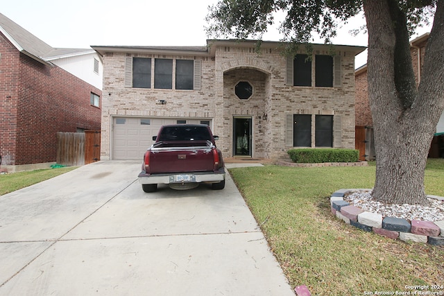 view of front of property with a front yard and a garage