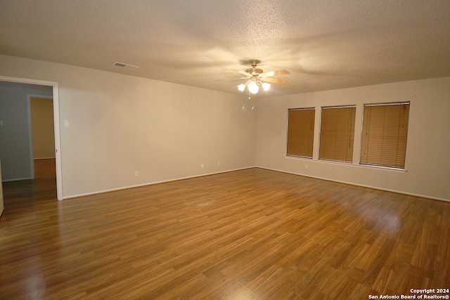 unfurnished room featuring ceiling fan, a textured ceiling, and hardwood / wood-style flooring