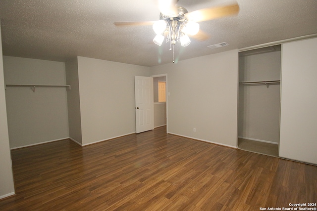 unfurnished bedroom featuring ceiling fan, dark hardwood / wood-style flooring, and a textured ceiling