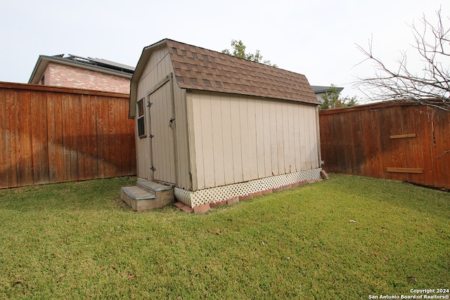 view of outdoor structure featuring a lawn