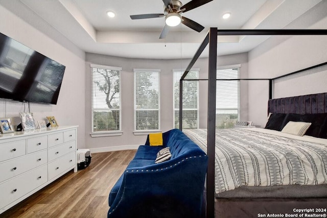 bedroom with ceiling fan and hardwood / wood-style floors