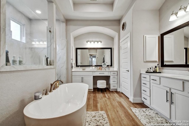 bathroom featuring hardwood / wood-style floors, vanity, and shower with separate bathtub