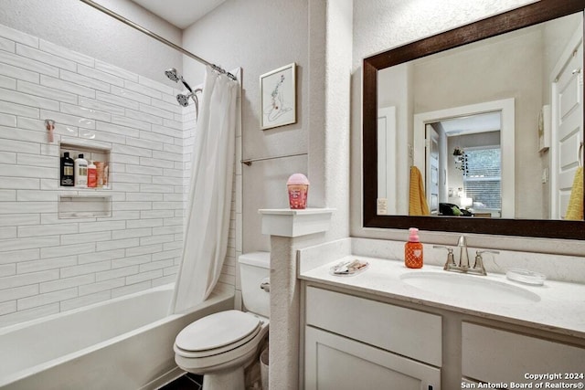 full bathroom with vanity, shower / bath combo, and toilet