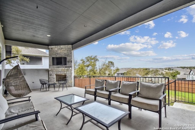 view of patio / terrace with an outdoor living space with a fireplace