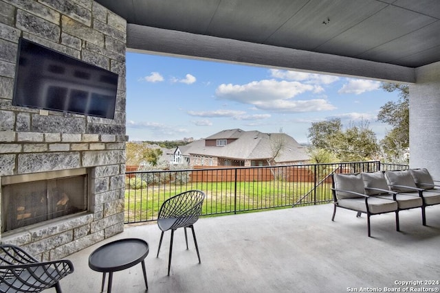 view of patio with an outdoor stone fireplace