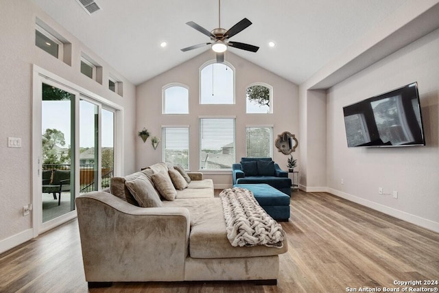 living room with ceiling fan, high vaulted ceiling, and wood-type flooring