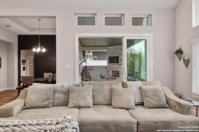 living room featuring hardwood / wood-style flooring, plenty of natural light, and an inviting chandelier