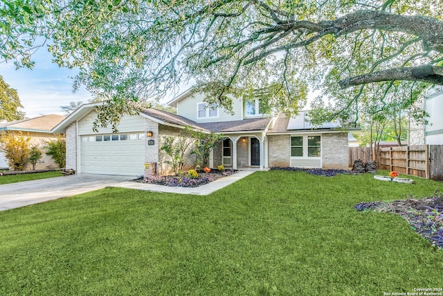 view of front of home with a front yard and a garage