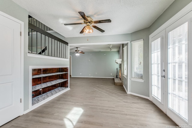 interior space with light hardwood / wood-style flooring, a wealth of natural light, and french doors