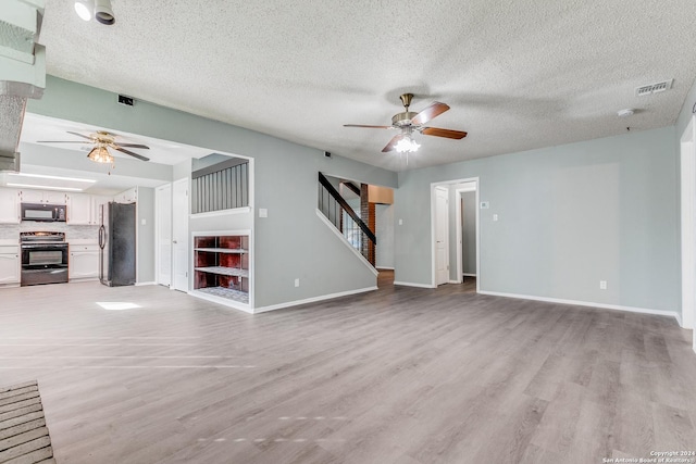 unfurnished living room with a textured ceiling, light hardwood / wood-style flooring, and ceiling fan