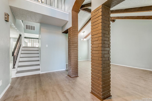 basement featuring a textured ceiling and light wood-type flooring