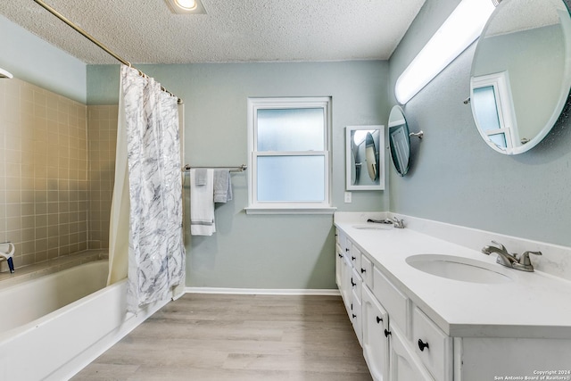 bathroom with hardwood / wood-style floors, vanity, a healthy amount of sunlight, and shower / bath combo