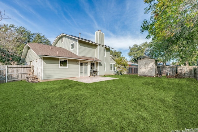 back of house with french doors, a patio, a storage shed, and a lawn