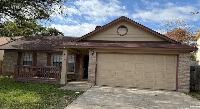 single story home featuring a garage and covered porch