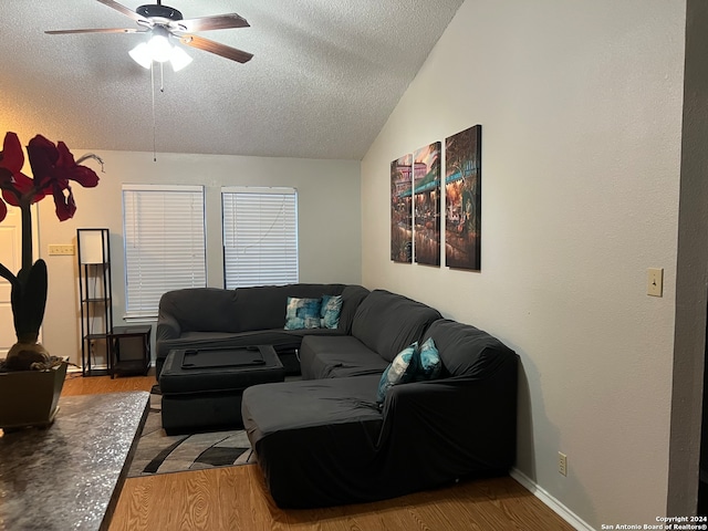 living room featuring wood-type flooring, a textured ceiling, vaulted ceiling, and ceiling fan