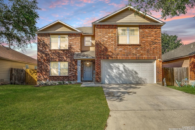 front of property with a garage and a lawn