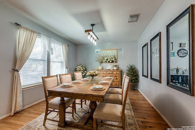 dining space with hardwood / wood-style floors