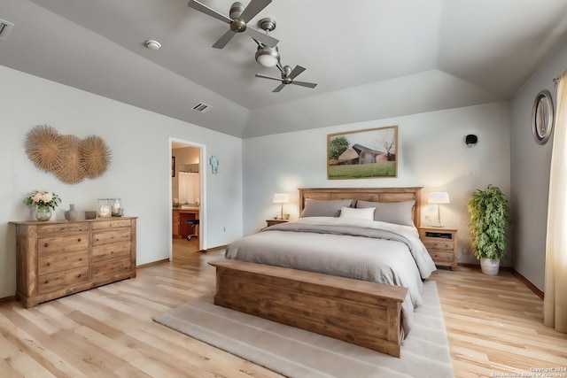 bedroom featuring ensuite bathroom, lofted ceiling, ceiling fan, and light wood-type flooring