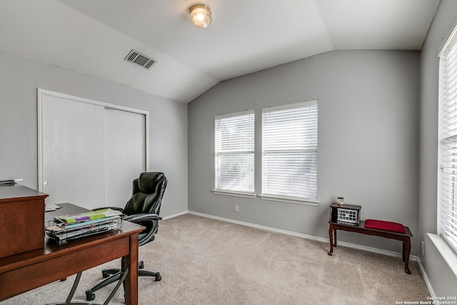 office with lofted ceiling and light carpet