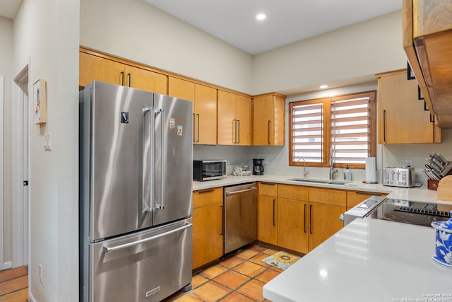 kitchen featuring light tile patterned floors, sink, and appliances with stainless steel finishes