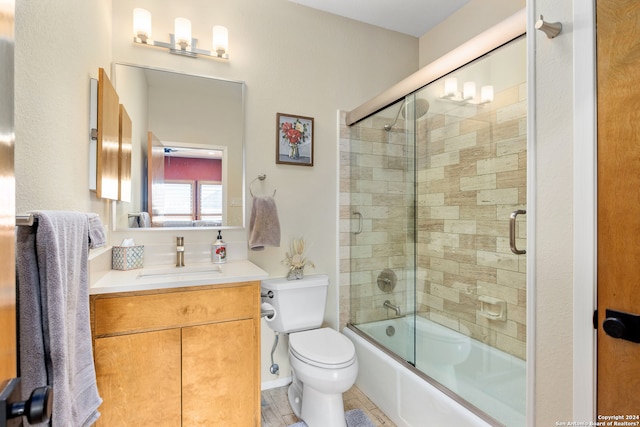 full bathroom with vanity, toilet, and shower / bath combination with glass door