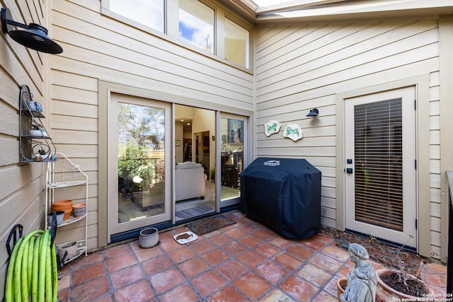 view of exterior entry with a patio