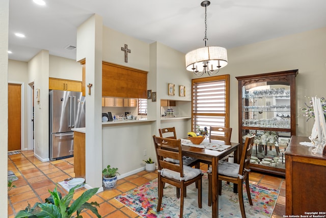 tiled dining area with an inviting chandelier