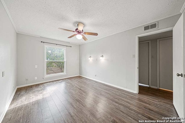 empty room featuring crown molding, ceiling fan, dark hardwood / wood-style flooring, and a textured ceiling