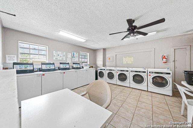 laundry area featuring ceiling fan, independent washer and dryer, a textured ceiling, and light tile patterned floors