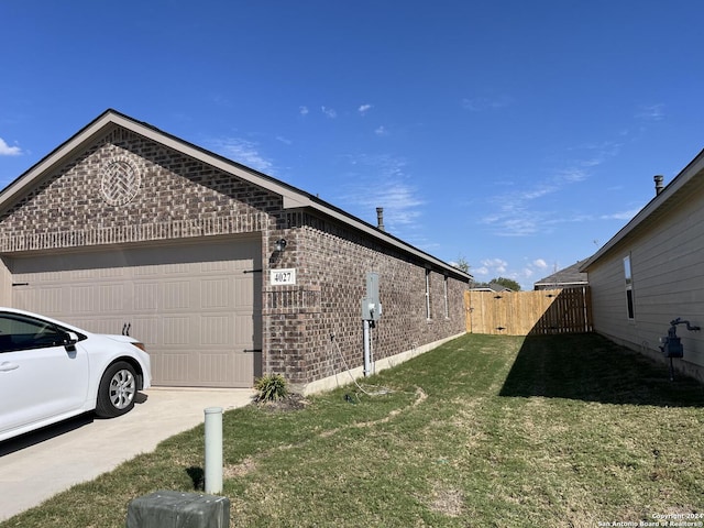 view of side of home with a yard and a garage