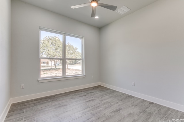 spare room featuring ceiling fan and light hardwood / wood-style floors