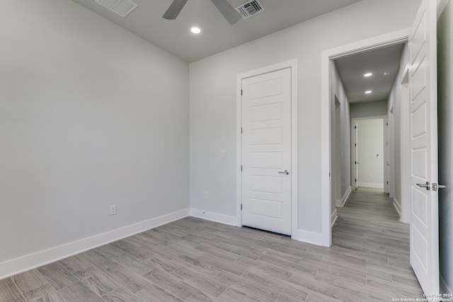 unfurnished room featuring ceiling fan and light wood-type flooring